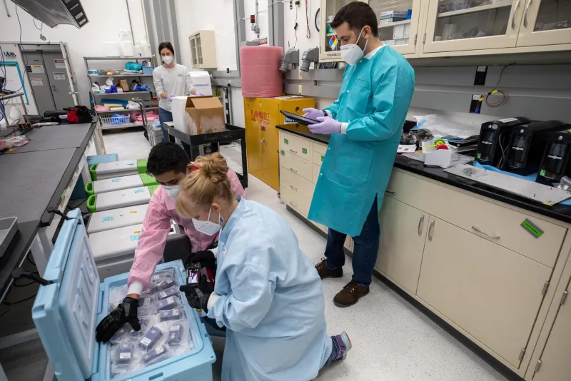 Researchers unpacking science experiments returned from the ISS (NASA)