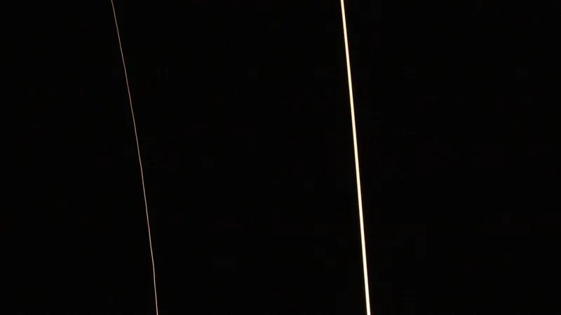 Long exposure of a Falcon 9 ascent and the booster returning to land (NASA)