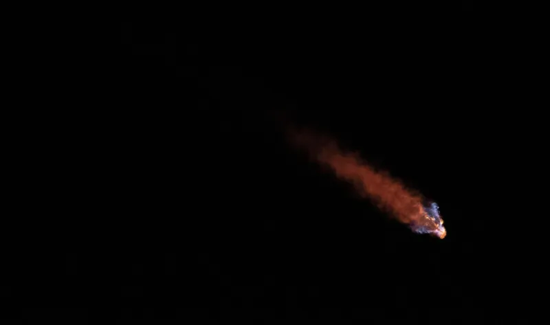 A Falcon Heavy rocket's exhaust trail climbing through the night sky (NASA)