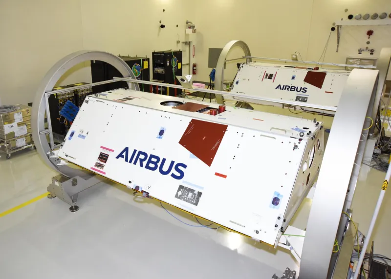 Two satellites in a clean room before launch (NASA)