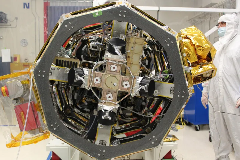 Reaction wheels inside a spacecraft bus during integration (NASA)